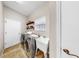 A laundry room equipped with a washer, dryer, utility sink, and shelving for storage at 9535 Norchester Cir, Tampa, FL 33647