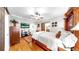 Well-lit main bedroom with wood floors, TV, ceiling fan, and a sliding barn door to the bathroom at 9535 Norchester Cir, Tampa, FL 33647