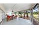 The expansive screened-in patio features a ceiling fan and seating area with views of the property at 9535 Norchester Cir, Tampa, FL 33647