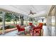 Relaxing screened patio with a ceiling fan and chairs offering peaceful outdoor enjoyment and comfort at 9535 Norchester Cir, Tampa, FL 33647