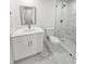 Modern bathroom featuring white vanity, toilet, and tiled shower with glass door and black and white accent tile at 10006 Memorial Hwy, Tampa, FL 33615