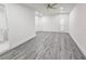 Large bedroom featuring neutral walls, vinyl floors, ceiling fan, and a window for natural light at 10006 Memorial Hwy, Tampa, FL 33615