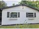 Charming home with window boxes and gray shutters at 10006 Memorial Hwy, Tampa, FL 33615