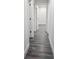 Clean hallway with gray vinyl floors and white walls, leading to various rooms at 10006 Memorial Hwy, Tampa, FL 33615