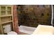 Bathroom features stone tile walls, a tub, and a vanity sink at 101 S Maywood Ave, Clearwater, FL 33765