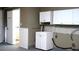 Garage features a wash sink, painted walls, and ample storage space, with access to the bathroom at 101 S Maywood Ave, Clearwater, FL 33765