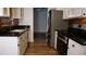 Well-lit kitchen with stainless steel appliances and black countertops at 101 S Maywood Ave, Clearwater, FL 33765