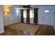 Bright living room with wood floors, ceiling fan, front door, and natural light at 101 S Maywood Ave, Clearwater, FL 33765