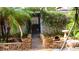 Charming outdoor space with tropical landscaping and brick-paved walkway for scenic appeal at 101 S Maywood Ave, Clearwater, FL 33765