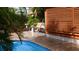 Backyard pool with covered seating area surrounded by tropical plants at 101 S Maywood Ave, Clearwater, FL 33765