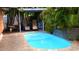 Backyard pool with a waterfall feature and a covered seating area at 101 S Maywood Ave, Clearwater, FL 33765
