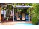Inviting outdoor seating area poolside with a gazebo structure and tropical plants for shade at 101 S Maywood Ave, Clearwater, FL 33765