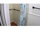 Shower stall features vintage tile and modern hardware with a blue shower curtain and a wood base at 101 S Maywood Ave, Clearwater, FL 33765