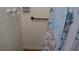 Enclosed shower features vintage tile and modern fixtures with a blue shower curtain at 101 S Maywood Ave, Clearwater, FL 33765