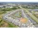 Aerial view of the neighborhood with houses, roads, and ponds at 10379 Bridgegate Heights Loop, San Antonio, FL 33576