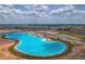 A scenic, high-angle shot of a community lagoon with crystal-clear turquoise water at 10379 Bridgegate Heights Loop, San Antonio, FL 33576