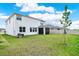Expansive backyard featuring a screened lanai, green grass, and privacy fence at 10379 Bridgegate Heights Loop, San Antonio, FL 33576
