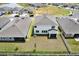 Aerial shot of the backyard of the house, featuring green grass, and privacy fence at 10379 Bridgegate Heights Loop, San Antonio, FL 33576