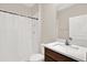 Bathroom featuring a stand-up shower with a full length shower curtain, toilet, and vanity with lighting at 10379 Bridgegate Heights Loop, San Antonio, FL 33576