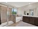 Bathroom featuring a large shower, soaking tub, and double sink vanity with great lighting at 10379 Bridgegate Heights Loop, San Antonio, FL 33576