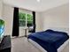 Bedroom featuring large windows, plush carpet, and a work station desk at 10379 Bridgegate Heights Loop, San Antonio, FL 33576