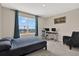 Bedroom featuring a large window, a desk with two monitors, and a chair at 10379 Bridgegate Heights Loop, San Antonio, FL 33576