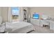 Well-lit bedroom showcasing large windows, a dresser, and a vanity at 10379 Bridgegate Heights Loop, San Antonio, FL 33576