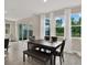 Bright dining room with a table and bench seating, and large windows overlooking backyard at 10379 Bridgegate Heights Loop, San Antonio, FL 33576