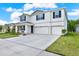 Charming two-story home featuring a three-car garage and manicured landscaping at 10379 Bridgegate Heights Loop, San Antonio, FL 33576