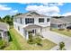 Charming two-story home featuring a three-car garage, a covered porch, and manicured landscaping at 10379 Bridgegate Heights Loop, San Antonio, FL 33576