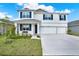 Beautiful two-story home with a three-car garage, well-kept lawn, and covered front porch at 10379 Bridgegate Heights Loop, San Antonio, FL 33576