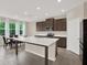 Bright kitchen featuring a large island, stainless appliances, and a cozy dining area at 10379 Bridgegate Heights Loop, San Antonio, FL 33576