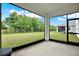Screened lanai with a view of the backyard and mature trees at 10379 Bridgegate Heights Loop, San Antonio, FL 33576