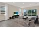 Open living room with tile floors, neutral walls, and sliding glass doors to the patio at 10379 Bridgegate Heights Loop, San Antonio, FL 33576