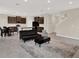 Open living space features dark wood cabinets, stainless steel appliances and black furniture at 10379 Bridgegate Heights Loop, San Antonio, FL 33576