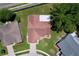 Aerial view of a home with a brown roof, surrounded by lush greenery, offering privacy and natural beauty at 10520 Tapestry Dr, Port Richey, FL 34668