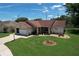 Home with a well-kept lawn, a welcoming porch, and an attached garage at 10520 Tapestry Dr, Port Richey, FL 34668