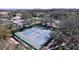 Overhead shot showcases community tennis courts surrounded by trees and walkways at 10520 Tapestry Dr, Port Richey, FL 34668