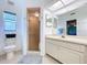 Bright bathroom featuring a glass door shower and a vanity with ample cabinet space at 10520 Tapestry Dr, Port Richey, FL 34668