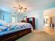 Spacious bedroom with light blue walls, ceiling fan and a large bed frame with storage drawers at 10520 Tapestry Dr, Port Richey, FL 34668