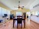 Spacious dining room featuring wood floors, a ceiling fan, and an open layout leading to other rooms at 10520 Tapestry Dr, Port Richey, FL 34668