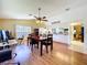 Comfortable dining room adjacent to the kitchen, featuring wood floors and bright natural light at 10520 Tapestry Dr, Port Richey, FL 34668