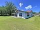 Well maintained home features a spacious green lawn and a screened porch providing outdoor enjoyment at 10520 Tapestry Dr, Port Richey, FL 34668