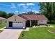 Charming single-story home featuring a well-manicured lawn and attached garage at 10520 Tapestry Dr, Port Richey, FL 34668