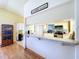 Kitchen features bar seating area into the Gathering room with white cabinetry at 10520 Tapestry Dr, Port Richey, FL 34668