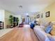 Open-concept living room showcasing hardwood floors and neutral paint, with natural light at 10520 Tapestry Dr, Port Richey, FL 34668