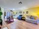 Spacious living room with hardwood floors, ample seating, and stylish decor at 10520 Tapestry Dr, Port Richey, FL 34668
