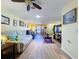 Open living room with hardwood floors, stylish decor, a ceiling fan, and neutral paint at 10520 Tapestry Dr, Port Richey, FL 34668