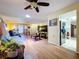 Comfortable living room with ceiling fan, light wood flooring, and TV at 10520 Tapestry Dr, Port Richey, FL 34668