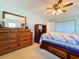 Well-lit primary bedroom featuring a large bed, dresser, and cozy atmosphere at 10520 Tapestry Dr, Port Richey, FL 34668